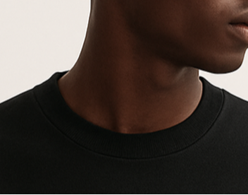 Person wearing a black sweatshirt with 'MINIMAL. PREMIUM.' text on a plain background
